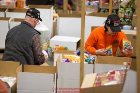 Volunteers sort and pack human food for the volunteers which will be working at the 20+ checkpoints durinig this year's 2016 Iditarod Race at the Airland Transport warehouse in Anchorage on Friday, February 19, 2016.