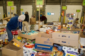 Volunteers sort and pack human food for the volunteers which will be working at the 20+ checkpoints durinig this year's 2016 Iditarod Race at the Airland Transport warehouse in Anchorage on Friday, February 19, 2016.