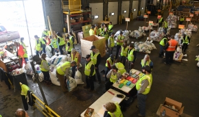 Iditarod volunteers process musher food drop bags for the 2020 Iditarod Trail Sled Dog Race at Aril Land Transport in Anchorage, AK on Wednesday, February 19, 2020. The bags with food and equipment will be shipped to Iditarod checkpoints along the trail. (Photo by Bob Hallinen)