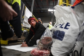 Iditarod musher Jessie Holmes marks a food drop bag for the 2020 Iditarod Trail Sled Dog Race at Air Land Transport in Anchorage, AK on Wednesday, February 19, 2020. (Photo by Bob Hallinen)