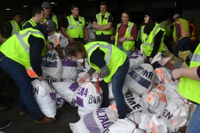 Iditarod volunteers process musher food drop bags for the 2020 Iditarod Trail Sled Dog Race at Aril Land Transport in Anchorage, AK on Wednesday, February 19, 2020. The bags with food and equipment will be shipped to Iditarod checkpoints along the trail. (Photo by Bob Hallinen)