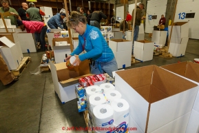 Volunteer Leslie Washburn boxes goods at the
