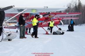 Volunteer Iditarod Air Force pilots line up their planes as they wait to load straw, musher drop bags, people food and HEET  at the Willow, Alaska airport during the Food Flyout on Saturday, February 20, 2016.  Iditarod 2016