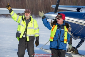 Volunteer Iditarod Air Force pilots, Dr. Bill Mayer and Bruce Moroney signal the OK to a taxing pilot at the Willow, Alaska airport during the Food Flyout on Saturday, February 20, 2016.  Iditarod 2016