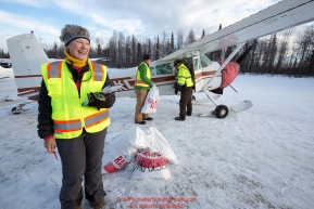 Volunteers, Leslie Washburn and John Hooley help Volunteer Iditarod Air Force pilot, Monte Mabry load his plane with musher drop bags at the Willow, Alaska airport during the Food Flyout on Saturday, February 20, 2016.  Iditarod 2016