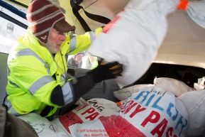 Volunteer Iditarod Air Force pilot, Dr. Bill Mayer loads musher drop bags into his plane at the Willow, Alaska airport during the Food Flyout on Saturday, February 20, 2016.  Iditarod 2016