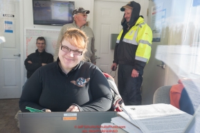 Volunteer load coordinator, Brittany Hanson does her magic at her radio and computer station inside the ACE fuels hut at the Willow, Alaska airport during the Food Flyout on Saturday, February 20, 2016.  Iditarod 2016