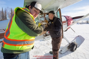 Volunteers help load Volunteer Iditarod Air Force pilot,Monte Mabry's plane with musher drop bags, people food and HEET  at the Willow, Alaska airport during the Food Flyout on Saturday, February 20, 2016.  Iditarod 2016