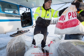 Volunteer Iditarod Air Force pilot, Greg Fischer loads hay, musher drop bags, people food and HEET into his plane at the Willow, Alaska airport during the Food Flyout on Saturday, February 20, 2016.  Iditarod 2016