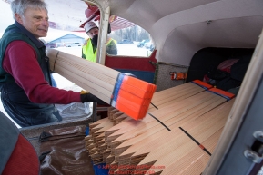 Volunteer Iditarod Air Force pilot, Ed Kornfield loads trail marker lathe into his plane at the Willow, Alaska airport during the Food Flyout on Saturday, February 20, 2016.  Iditarod 2016