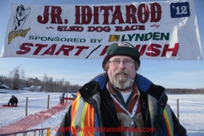 Saturday February 25, 2012  Long-time Jr. Iditarod volunteer Terry Langholz of Knik is honorary musher for this year's 2012 Jr. Iditarod.  He poses at the start line on Knik Lake during the Junior Iditarod start.