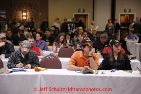 Husband and wife Allen Moore and Aliy Zirkle listen during the mandatory musher meeting at the Millenium hotel two days prior to the start of Iditarod 2013.Photo (C) Jeff Schultz/IditarodPhotos.com  Do not reproduce without permission