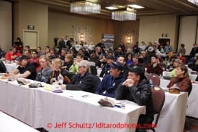 Mushers listen during the mandatory musher meeting at the Millenium hotel two days prior to the start of Iditarod 2013.Photo (C) Jeff Schultz/IditarodPhotos.com  Do not reproduce without permission