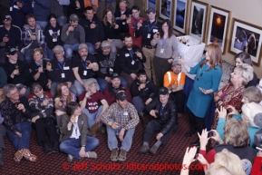 Millenium Alaska Hotel manager Carol Fraser gives a goodwill toast to the entire field of 66 2013 Iditarod mushers  during the mandatory musher meeting at the Millenium hotel two days prior to the start of Iditarod 2013.Photo (C) Jeff Schultz/IditarodPhotos.com  Do not reproduce without permission