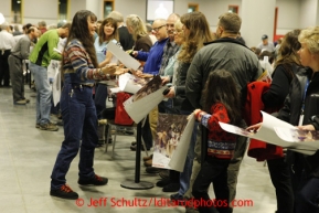 Thursday February 28, 2013  Musher Jessie Royer runs the gauntlet of autograph seekers at the musher drawing banquet held at the Dena'ina Convention Center in Anchorage two days prior to the start of Iditarod 2013.Photo (C) Jeff Schultz/IditarodPhotos.com  Do not reproduce without permission