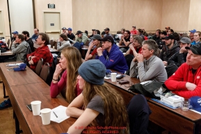 Mushers listen to Race Manager and Marshal Mark Nordman at the mandatory musher meeting at the Lakefront Anchorage hotel in Anchorage, Alaska. Thursday February 28, 2019 Photo by Jeff Schultz/  (C) 2019  ALL RIGHTS RESERVED