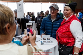 Ryan Redington has his photo taken with a race fan at the musher pre-race banquet at the Denaina Convention center for Iditarod 2019Photo by Jeff Schultz/  (C) 2019  ALL RIGHTS RESERVED