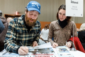 Jessie Holmes signs an autograph for a race fan at the musher pre-race banquet at the Denaina Convention center for Iditarod 2019Photo by Jeff Schultz/  (C) 2019  ALL RIGHTS RESERVED