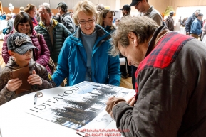 Martin Buser signs autographs for races fans at the musher pre-race banquet at the Dena'ina Convention center for Iditarod 2019Photo by Jeff Schultz/  (C) 2019  ALL RIGHTS RESERVED