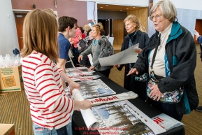 Face fans get their free ExxonMobil poster at the musher pre-race banquet at the Denaina Convention center for Iditarod 2019Photo by Jeff Schultz/  (C) 2019  ALL RIGHTS RESERVED