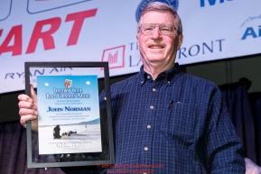 John Norman shows off his plaque after receiving the Iditarod Trail Foundation Founders award at the pre-race musher drawing banquet at the Dena'ina convention center in Anchorage, Alaska prior to the 2019 Iditarod Trail Sled Dog RacePhoto by Jeff Schultz/  (C) 2019  ALL RIGHTS RESERVED