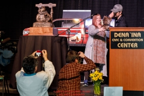 Matthew Failor picks his drawing position from a mukluk at the pre-race musher drawing banquet at the Dena'ina convention center in Anchorage, Alaska prior to the 2019 Iditarod Trail Sled Dog RacePhoto by Jeff Schultz/  (C) 2019  ALL RIGHTS RESERVED