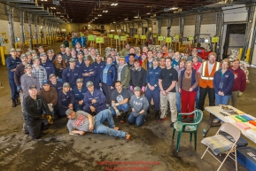 Iditarod volunteers pose for a group photo during the food drop day.  The goal is to unload, weigh, organize and stack the mushers food bags destined for the checkpoints on the 2017 Iditarod at the Airland Transport warehouse facilities in Anchorage Alaska.Wednesday February 15, 2017.Photo by Jeff Schultz/SchultzPhoto.com  (C) 2017  ALL RIGHTS RESVERVED