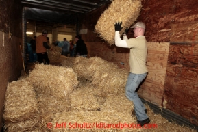 Tom Kohnke unloads a portion of the1500 bales of straw from a shipping container at Airland Transport in Anchorage to be sent out to the 22 checkpoints along the Iditarod trail Thursday, Feb. 7, 2013.