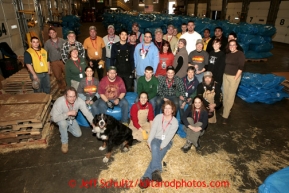 33 volunteers who bagged, palletized and added postage to 1500 bales of straw at Airland Transport in Anchorage to be sent out to the 22 checkpoints along the Iditarod trail pose for a picture together Thursday, Feb. 7, 2013.