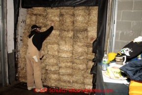 Ed Sundeen prepares to unload some of the1500 bales of straw at Airland Transport in Anchorage to be sent out to the 22 checkpoints along the Iditarod trail Thursday, Feb. 7, 2013.