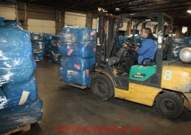 Thursday February 9, 2012   An Airland Transort employee uses a fork-lift to transfer 12 of the 1200 +  bales of straw for shipment to the Iditarod checkpoints at the Airland Transport warehouse in Anchorage.