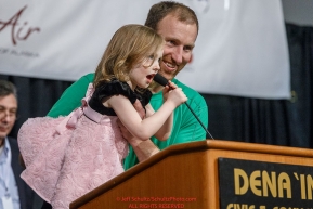 Kelly Maixner and his daughter tell his starting position number at the 2016 Iditarod musher position drawing banquet at the Dena'ina convention center in Anchorage, Alaska on Thursday March 3, 2016  Â© Jeff Schultz/SchultzPhoto.com ALL RIGHTS RESERVEDDO NOT REPRODUCE WITHOUT PERMISSION