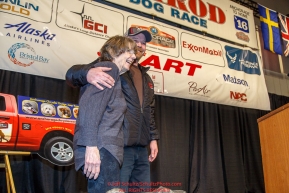 Joanne Potts receives the honorary musher award from Aaron Burmeister at the 2016 Iditarod musher position drawing banquet at the Dena'ina convention center in Anchorage, Alaska on Thursday March 3, 2016  Â© Jeff Schultz/SchultzPhoto.com ALL RIGHTS RESERVEDDO NOT REPRODUCE WITHOUT PERMISSION