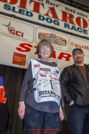 Joanne Potts receives the honorary musher award from Aaron Burmeister at the 2016 Iditarod musher position drawing banquet at the Dena'ina convention center in Anchorage, Alaska on Thursday March 3, 2016  Â© Jeff Schultz/SchultzPhoto.com ALL RIGHTS RESERVEDDO NOT REPRODUCE WITHOUT PERMISSION