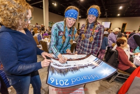 Kristy and Anna Berington sign an Iditarod poster for a fan at the 2016 Iditarod musher position drawing banquet at the Dena'ina convention center in Anchorage, Alaska on Thursday March 3, 2016  Â© Jeff Schultz/SchultzPhoto.com ALL RIGHTS RESERVEDDO NOT REPRODUCE WITHOUT PERMISSION