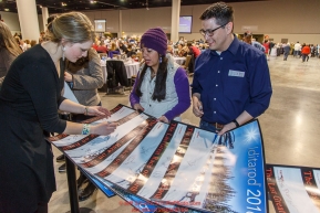 Lisbet Norris signs a gaggle of Iditarod posters for race fans at the 2016 Iditarod musher position drawing banquet at the Dena'ina convention center in Anchorage, Alaska on Thursday March 3, 2016  Â© Jeff Schultz/SchultzPhoto.com ALL RIGHTS RESERVEDDO NOT REPRODUCE WITHOUT PERMISSION