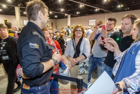 Martin Buser poses for a photo with race fans at the 2016 Iditarod musher position drawing banquet at the Dena'ina convention center in Anchorage, Alaska on Thursday March 3, 2016  Â© Jeff Schultz/SchultzPhoto.com ALL RIGHTS RESERVEDDO NOT REPRODUCE WITHOUT PERMISSION