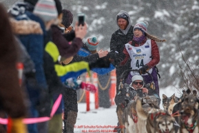 Tara Cicatello gives high-fives to spectators on the bike/ski trail during the ceremonial start day of the 2018 Iditarod in Anchorage, Alaska on Saturday, March 3 2018.Photo by Jeff Schultz/SchultzPhoto.com  (C) 2018  ALL RIGHTS RESERVED