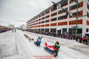 Michelle Phillips waves to the crowd as she runs down 4th avenue during the ceremonial start of the 2018 Iditarod in Anchorage, Alaska on Saturday, March 3, 2018.Photo by Jeff Schultz/SchultzPhoto.com  (C) 2018  ALL RIGHTS RESERVED