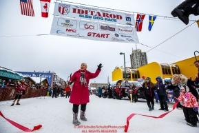 The original Teacher on the Trail Finney cuts the ceremonial ribbon during the ceremonial start of the 2018 Iditarod in Anchorage, Alaska on Saturday, March 1 2018.Photo by Jeff Schultz/SchultzPhoto.com  (C) 2018  ALL RIGHTS RESERVED