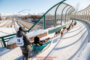 Robert Redington runs over the Tudor Road bridge during the Ceremonial Start of the 2017 Iditarod in Anchorage on Saturday March 4, 2017 Photo by Jeff Schultz/SchultzPhoto.com  (C) 2017  ALL RIGHTS RESVERVED
