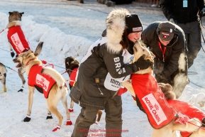Laura Neese gives her dogs a pet and hug just prior to leaving the Ceremonial Start of the 2017 Iditarod in Anchorage on Saturday March 4, 2017 Photo by Jeff Schultz/SchultzPhoto.com  (C) 2017  ALL RIGHTS RESVERVED