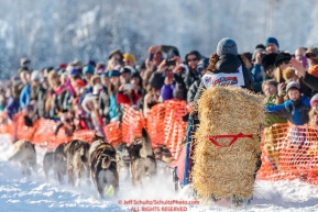 Michelle Phillips carrying the essential bail of straw on Willow Lake at the Official Start of the 2018 Iditarod Sled Dog Race in Willow, Alaska on March 04, 2018. Photo by Jeff Schultz/SchultzPhoto.com  (C) 2018  ALL RIGHTS RESERVED