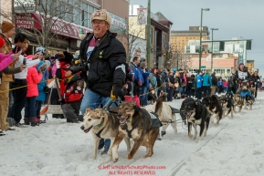 Ketil Reitan's handler brings the dogs to the 4th avenue start line during the Ceremonial Start of the 2016 Iditarod in Anchorage, Alaska.  March 05, 2016