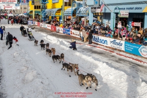 Pete Kaiser runs down 4th avenue leaving the start line during the Ceremonial Start of the 2016 Iditarod in Anchorage, Alaska.  March 05, 2016