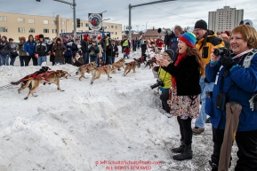 Crowds watch musher Bob Bundtzen run down 4th avenue during the Ceremonial Start of the 2016 Iditarod in Anchorage, Alaska.  March 05, 2016