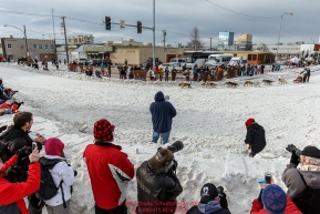 Crowds watch Wade Marrs as he rounds the turn at Cordova Street and 4th avenue during the Ceremonial Start of the 2016 Iditarod in Anchorage, Alaska.  March 05, 2016