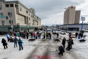 Robert Sorlie runs down Cordova Street crossing 5th Avenue during  Ceremonial Start of the 2016 Iditarod in Anchorage, Alaska.  March 05, 2016