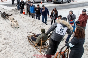 Justin Savidis runs down Cordova Street giving high-fives to spectators during the Ceremonial Start of the 2016 Iditarod in Anchorage, Alaska.  March 05, 2016