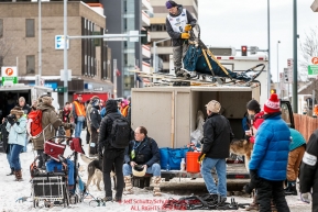 Ketil Reitan takes his sled off the roof of his dog truck in the staging area of  the Ceremonial Start of the 2016 Iditarod in Anchorage, Alaska.  March 05, 2016